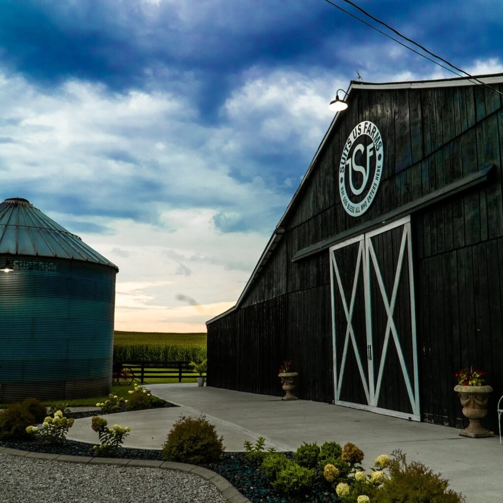 Suits US Farm Barn Venue, with landscape in front and a grain silo to the left of the barn