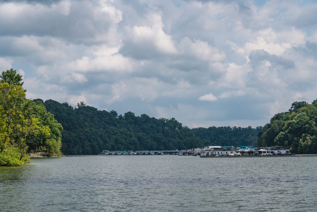 Houseboats sitting on Lake Cumberland, some dark clouds in the sky.