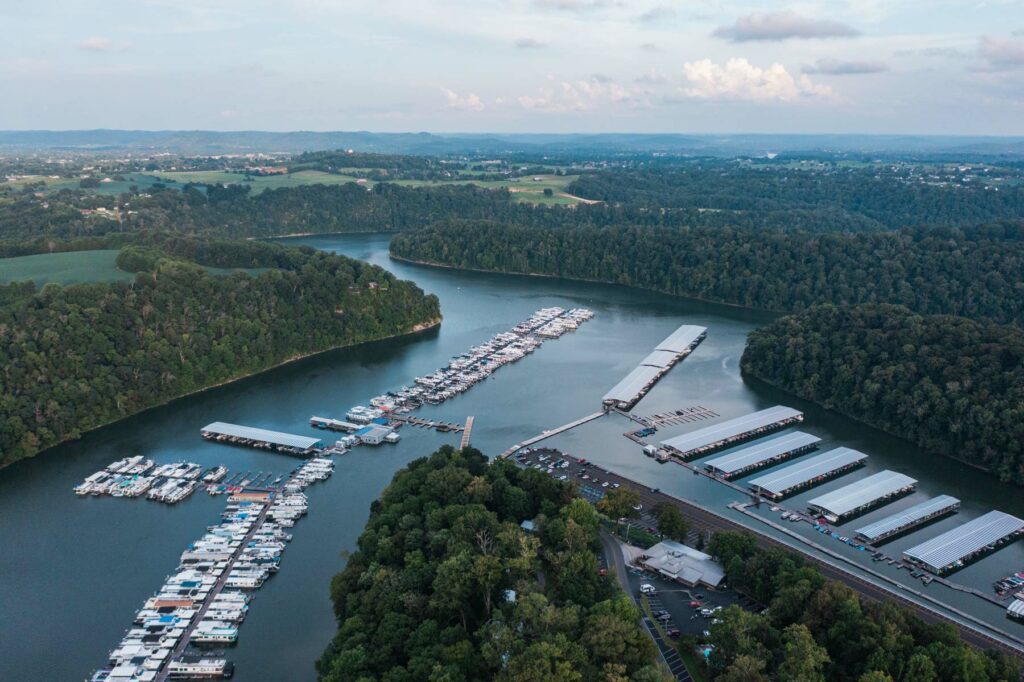 Lake marina and wooded shoreline viewed from above.