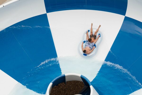 Kids in raft on water slide.