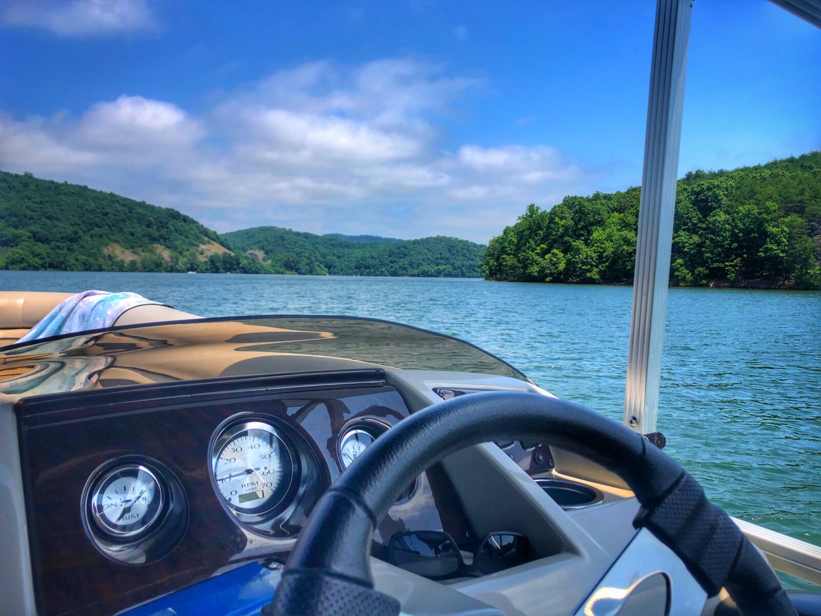 Looking at the lake behind the wheel of the pontoon.